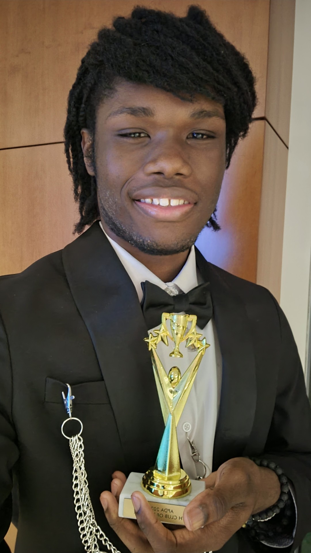 Marcel Cato holding a trophy at NYU Stern School of Business